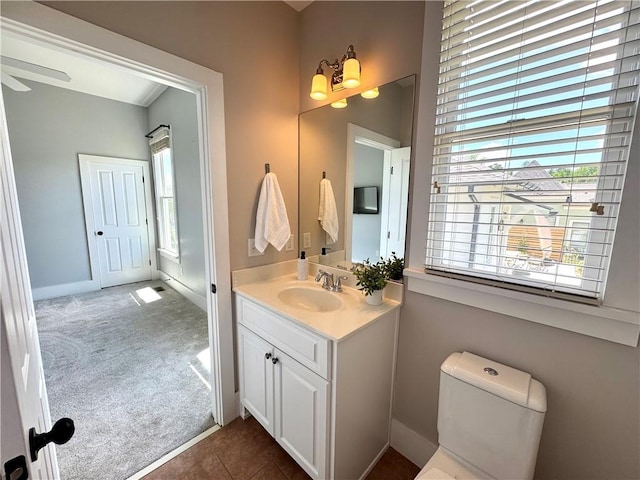 bathroom featuring toilet, tile patterned flooring, and vanity