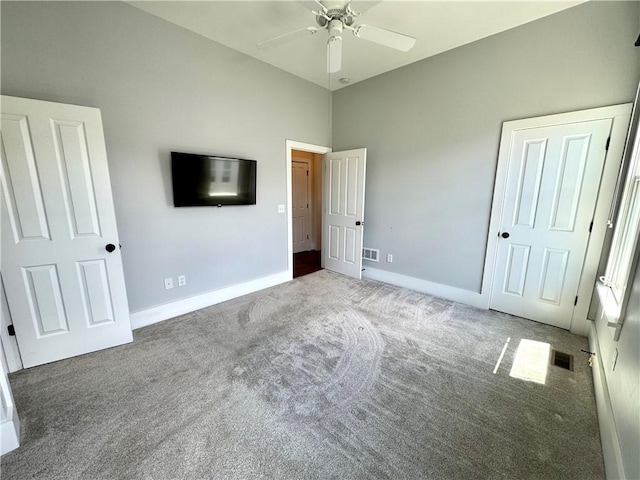 unfurnished bedroom with baseboards, ceiling fan, carpet flooring, and visible vents