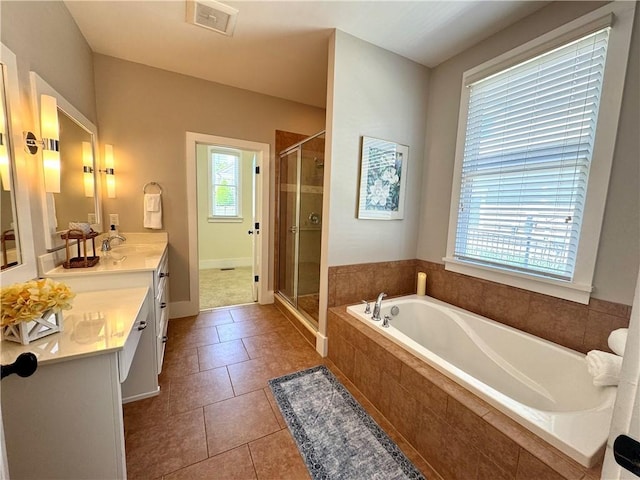 bathroom with vanity, visible vents, tile patterned floors, a shower stall, and a garden tub