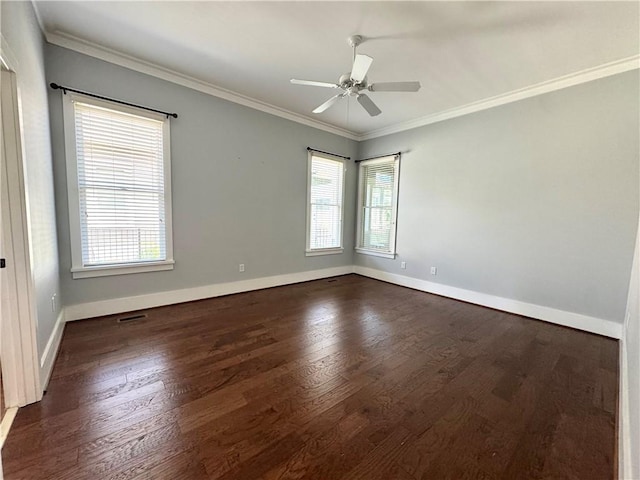 empty room featuring a ceiling fan, baseboards, crown molding, and dark wood-style floors