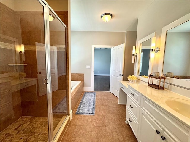 bathroom with a stall shower, vanity, a bath, and tile patterned floors