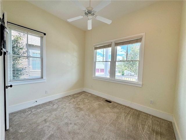 empty room with carpet, baseboards, and plenty of natural light
