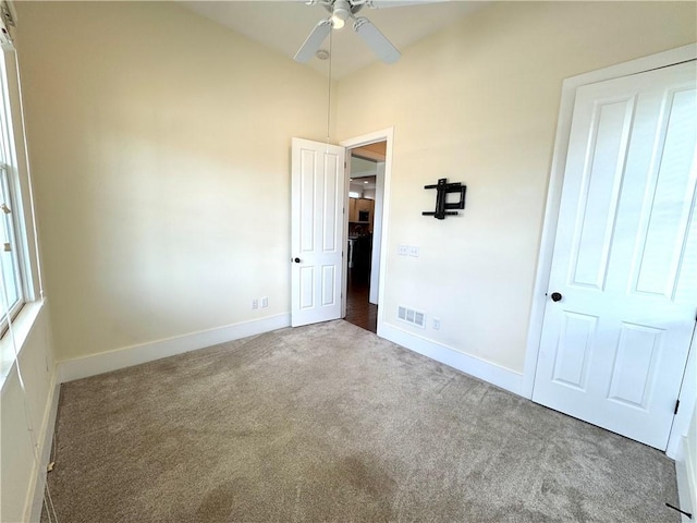 unfurnished bedroom featuring baseboards, carpet flooring, and visible vents