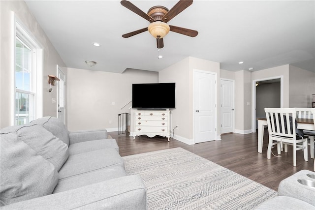 living room featuring baseboards, ceiling fan, recessed lighting, and dark wood-style flooring