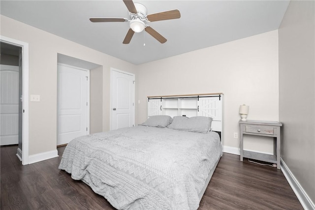 bedroom with dark wood-type flooring, baseboards, and a ceiling fan