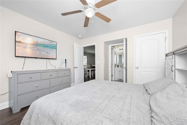 bedroom with baseboards, a ceiling fan, ensuite bathroom, and dark wood-style flooring