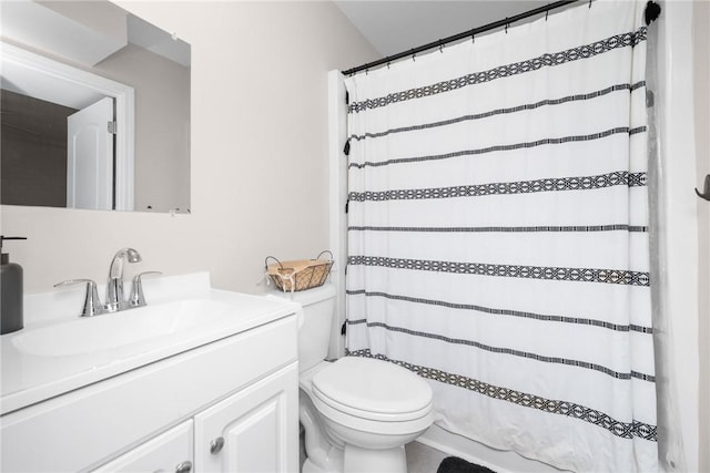 bathroom featuring toilet, a shower with shower curtain, and vanity