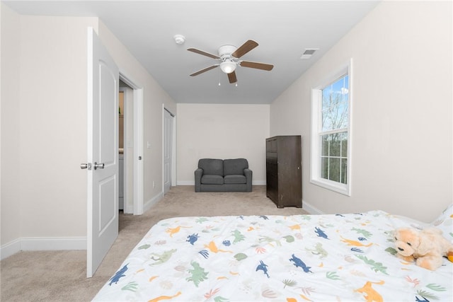 bedroom featuring light colored carpet, visible vents, baseboards, and a ceiling fan