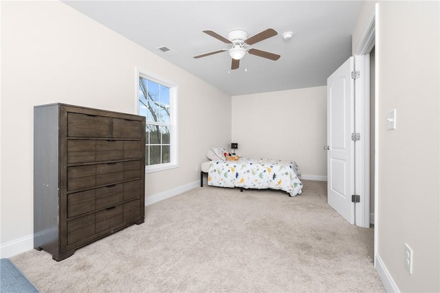 carpeted bedroom featuring baseboards, visible vents, and a ceiling fan