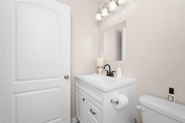 bathroom with toilet and vanity