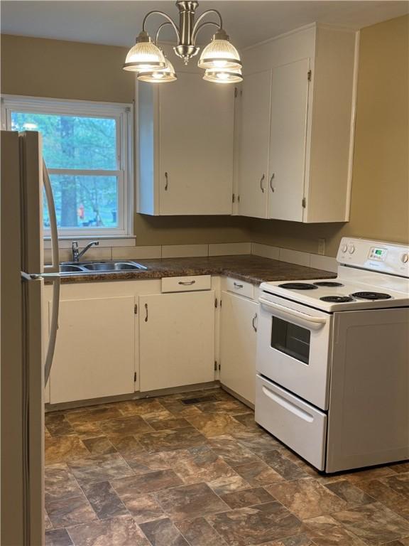 405 Casey St, Anderson, SC 29624 - kitchen with white appliances, white cabinetry, stone finish flooring, a sink, and dark countertops