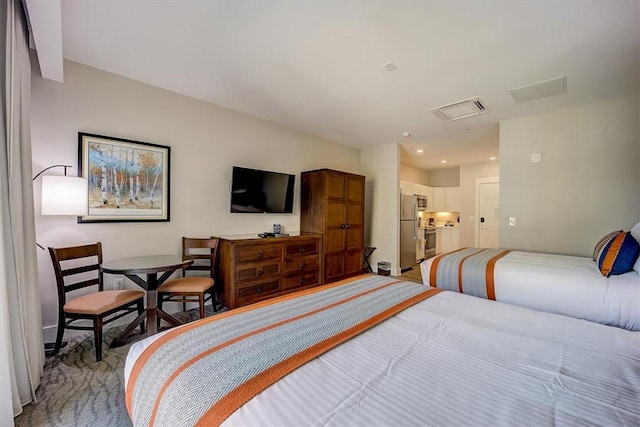 bedroom featuring visible vents, freestanding refrigerator, and recessed lighting