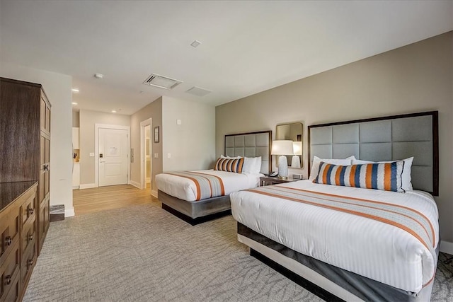 bedroom with carpet, visible vents, and baseboards