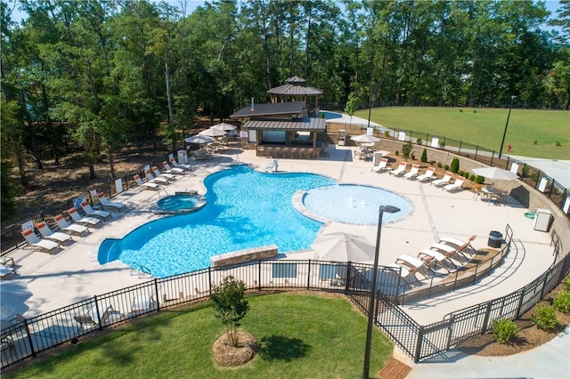 community pool featuring a patio, a gazebo, and fence