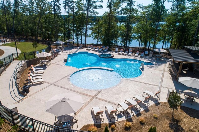 community pool with a community hot tub, a patio area, and fence