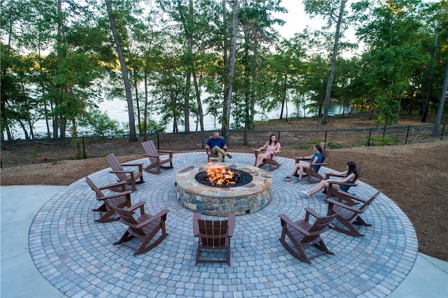 view of patio / terrace featuring an outdoor fire pit and fence