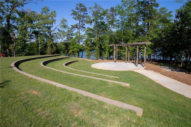 view of home's community with a pergola and a lawn
