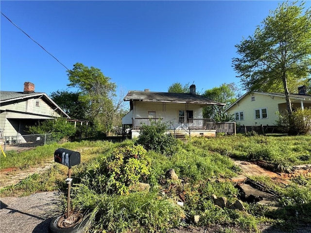back of property featuring fence