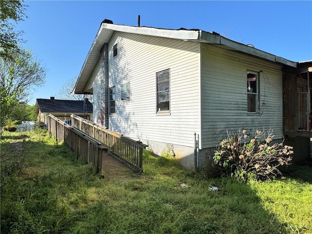 view of property exterior with crawl space and fence