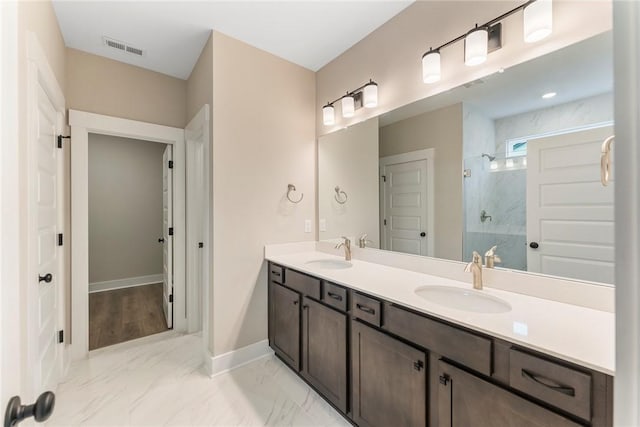 full bath with a sink, visible vents, baseboards, and a stall shower