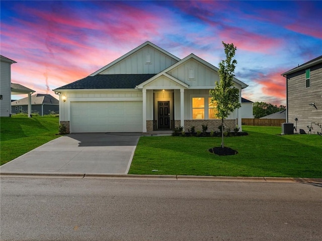 view of front of property featuring board and batten siding, driveway, a lawn, an attached garage, and brick siding