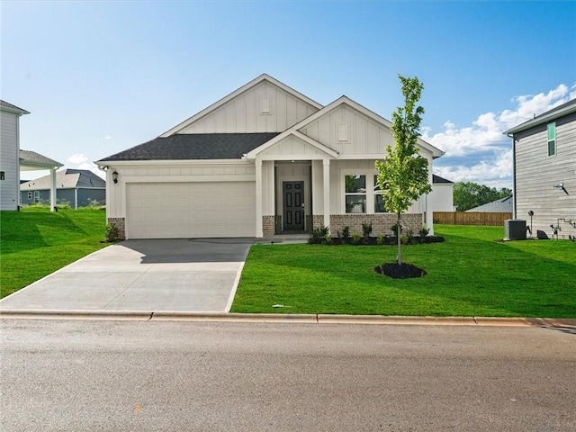 craftsman inspired home with board and batten siding, a garage, driveway, a front lawn, and brick siding