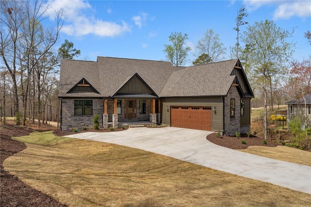 view of front facade featuring concrete driveway, stone siding, a front yard, a garage, and a shingled roof