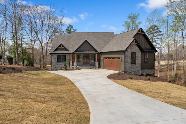 craftsman-style house with concrete driveway, stone siding, board and batten siding, a front yard, and a garage