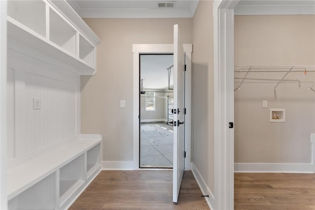 interior space featuring visible vents, baseboards, and wood finished floors