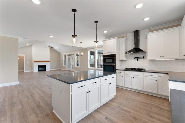 kitchen with dobule oven black, wall chimney exhaust hood, gas cooktop, dark countertops, and lofted ceiling