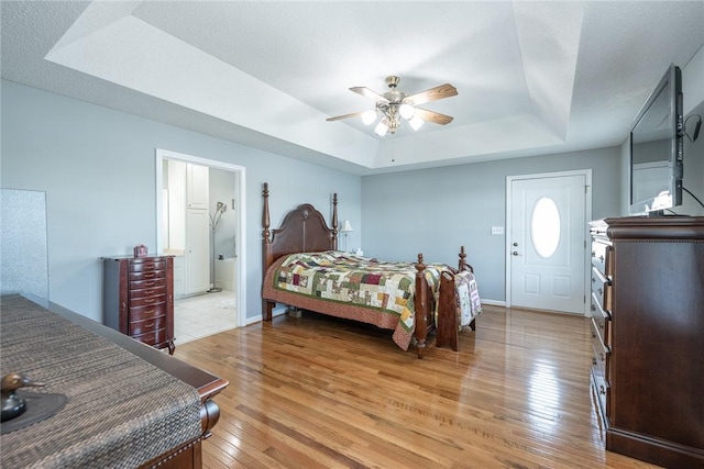 417 Mcgill Cir, Iva, SC 29655 - bedroom with a raised ceiling, light wood finished floors, a ceiling fan, and connected bathroom