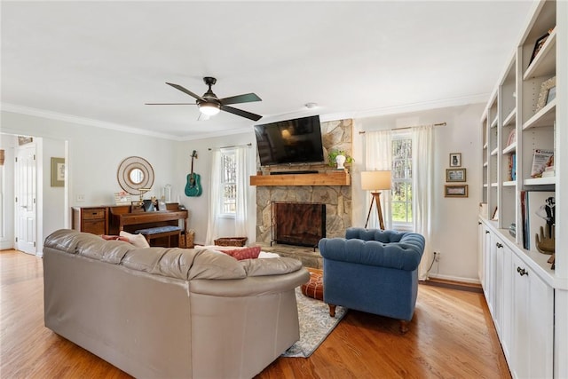 living room with ornamental molding, ceiling fan, and light wood-style floors