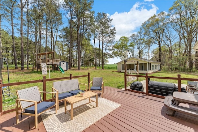 deck with a playground, an outdoor structure, and a lawn