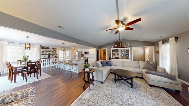 15009 Beacon Ridge Dr, Seneca, SC 29678 - living room with dark wood-type flooring, a ceiling fan, lofted ceiling, and a chandelier