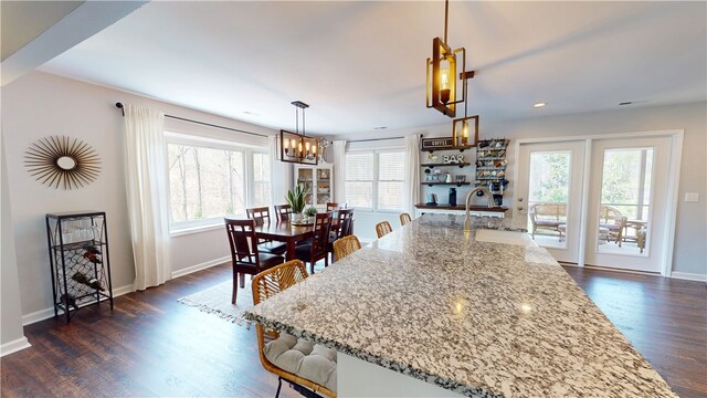 15009 Beacon Ridge Dr, Seneca, SC 29678 - kitchen with a chandelier, dark wood finished floors, light stone countertops, baseboards, and recessed lighting