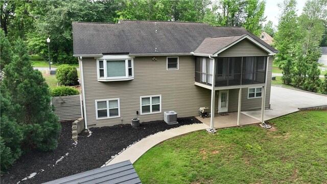 15009 Beacon Ridge Dr, Seneca, SC 29678 - back of house featuring a patio, a yard, roof with shingles, central AC unit, and a sunroom
