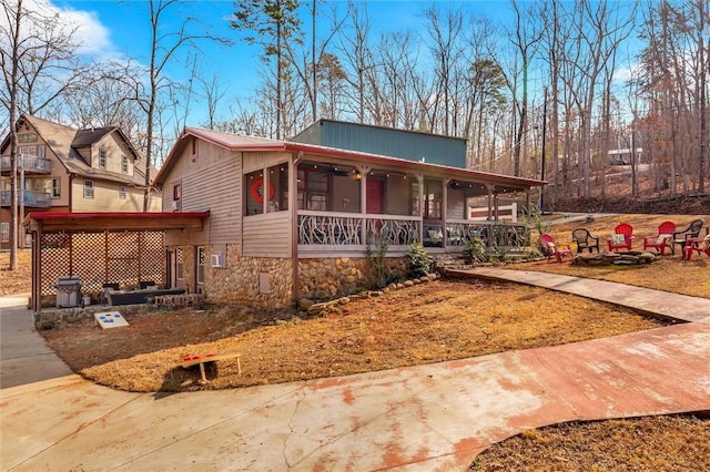 124-130 S Port Bass Dr, Fair Play, SC 29643 - view of front of property featuring a porch, an outdoor fire pit, and stone siding