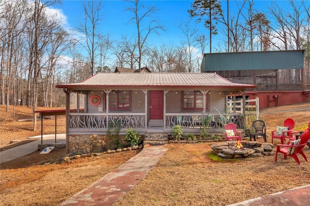124-130 S Port Bass Dr, Fair Play, SC 29643 - view of front of house with an outdoor fire pit, metal roof, and a porch
