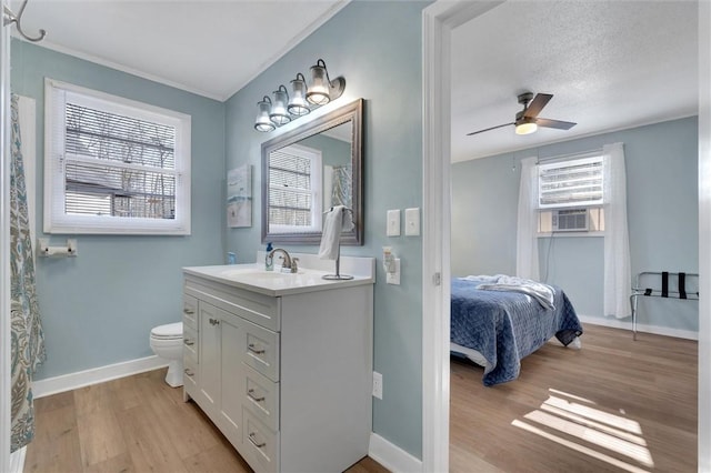 124-130 S Port Bass Dr, Fair Play, SC 29643 - ensuite bathroom featuring ceiling fan, vanity, toilet, wood finished floors, and baseboards