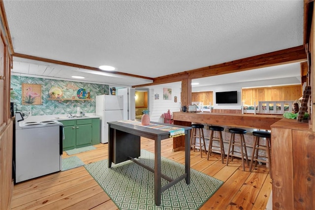 124-130 S Port Bass Dr, Fair Play, SC 29643 - kitchen featuring light wood-style flooring, green cabinetry, freestanding refrigerator, and stove