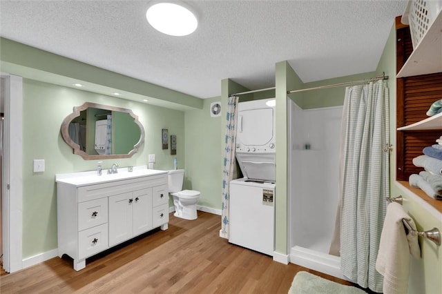 124-130 S Port Bass Dr, Fair Play, SC 29643 - full bathroom with a stall shower, wood finished floors, stacked washer and clothes dryer, and a textured ceiling