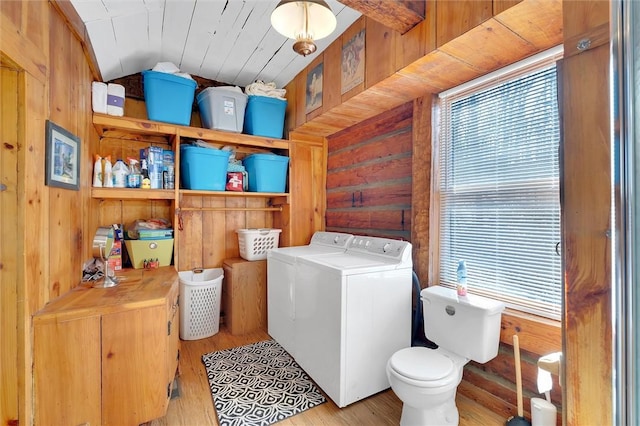 124-130 S Port Bass Dr, Fair Play, SC 29643 - clothes washing area featuring washer and clothes dryer, wooden walls, laundry area, and wood finished floors