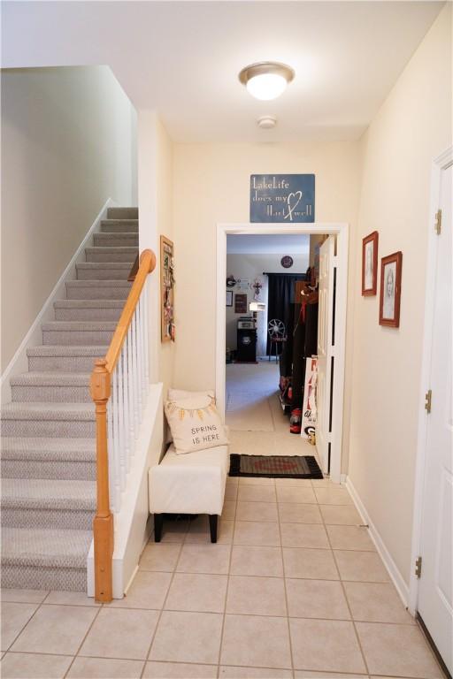 1226 Bowersville Hwy, Hartwell, GA 30643 - hall with tile patterned floors, stairs, and baseboards