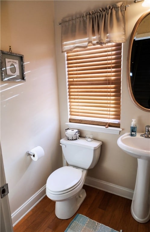 1226 Bowersville Hwy, Hartwell, GA 30643 - bathroom with toilet, wood finished floors, a sink, and baseboards