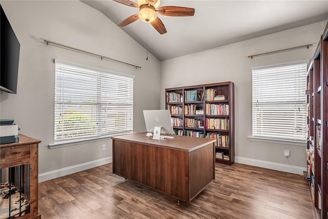 office space featuring dark wood finished floors, lofted ceiling, baseboards, and ceiling fan