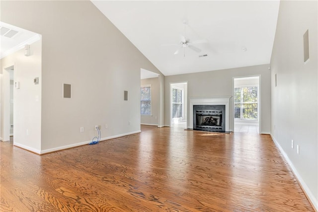unfurnished living room featuring high vaulted ceiling, a ceiling fan, visible vents, wood finished floors, and baseboards