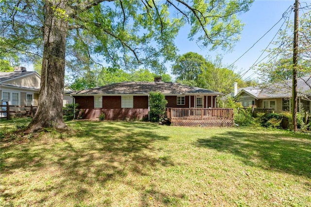 back of house featuring a wooden deck, a lawn, and a chimney