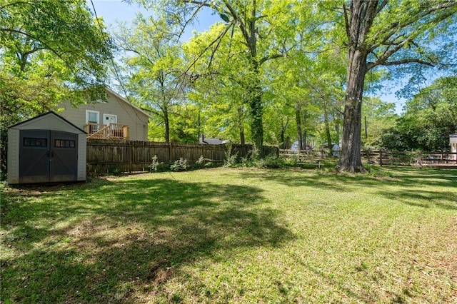 view of yard featuring a fenced backyard, an outdoor structure, and a storage unit