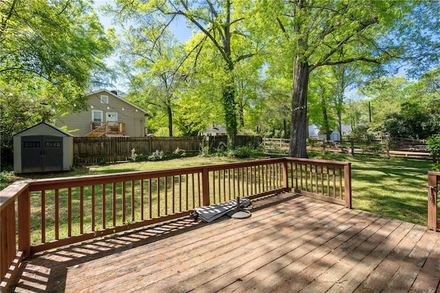 deck with a yard, a fenced backyard, an outdoor structure, and a shed