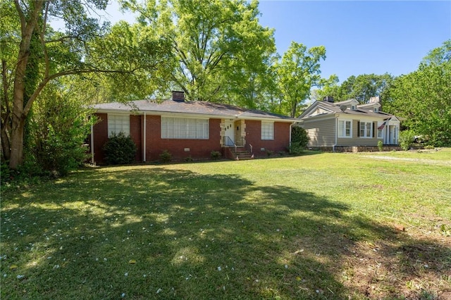 ranch-style house with a front yard, brick siding, and a chimney